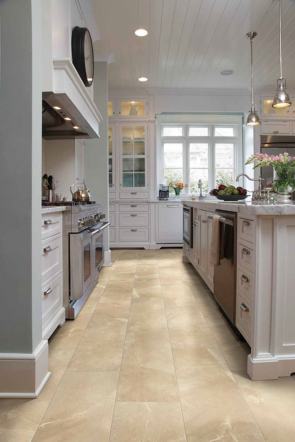 Modern colonial kitchen with stone countertops and stainless steel appliances and recessed lighting.