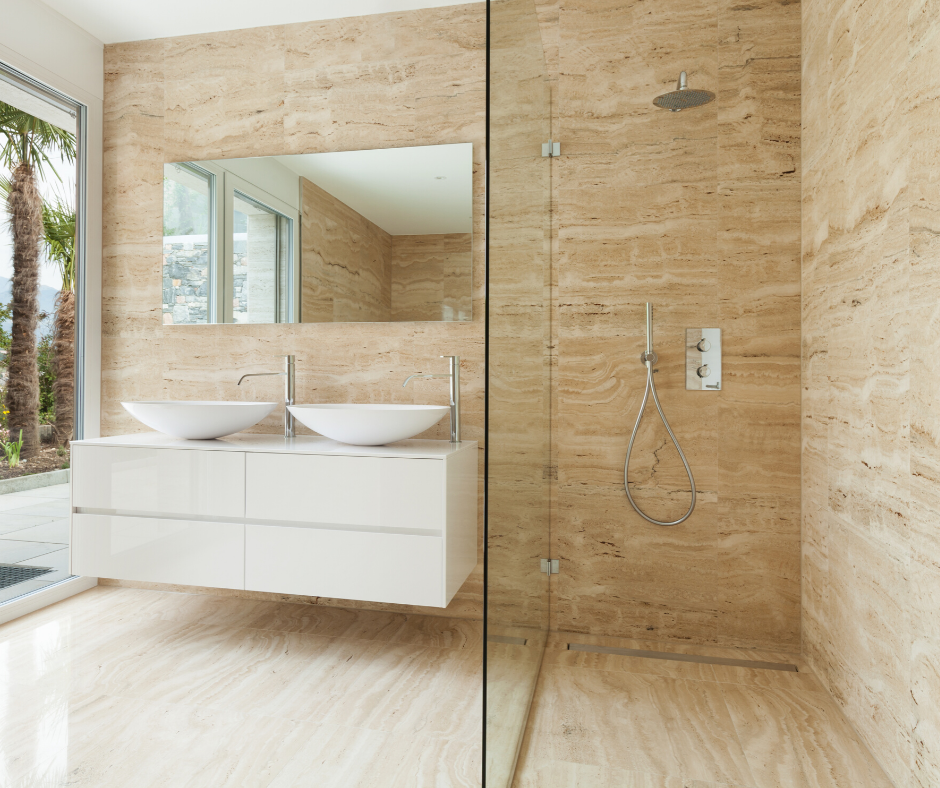 A modern 2020 themed bathroom with an open shower design, large white washbasins, and a neutral stone tile look.